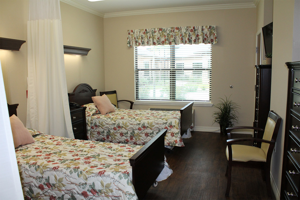 Semi-private room with separate furnishings and tv